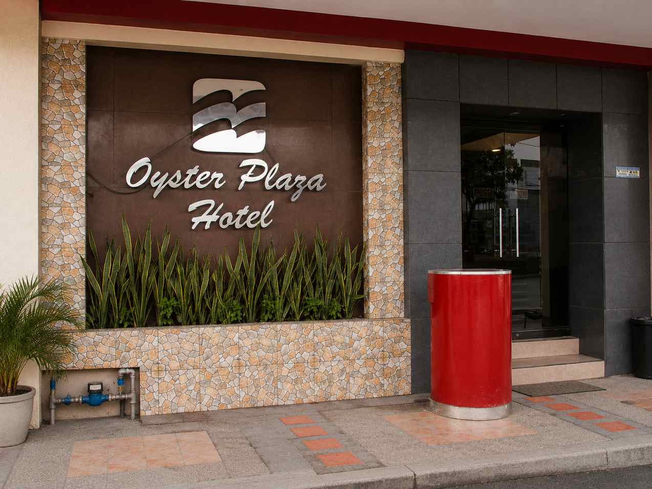 Oyster Plaza Hotel entrance illuminated at dusk in Parañaque